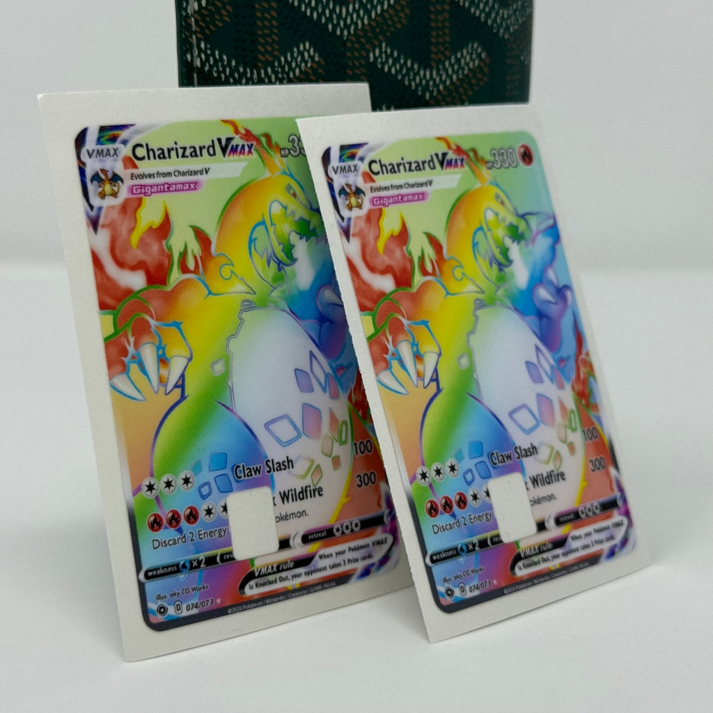 Set of two identical Charizard VMAX Pokémon credit card stickers displayed side by side against green patterned wallet, showing Gigantamax fire dragon with rainbow holographic effects and vibrant TCG card artwork from Kibakiba.co