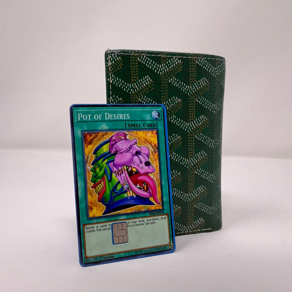 Set of two identical Pot of Desires Yu-Gi-Oh! credit card stickers displayed side by side against green patterned wallet, showing complete spell card artwork with purple demon emerging from mystical pot, premium vinyl quality from Kibakiba.co